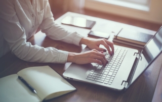 Person using keyboard on a laptop